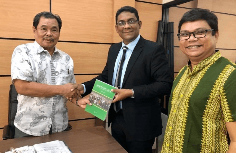 Minister Mohagher Iqbal presents his book to BI's Asia Regional Director M. Anowar Hossainin Cotabato, Philippines.