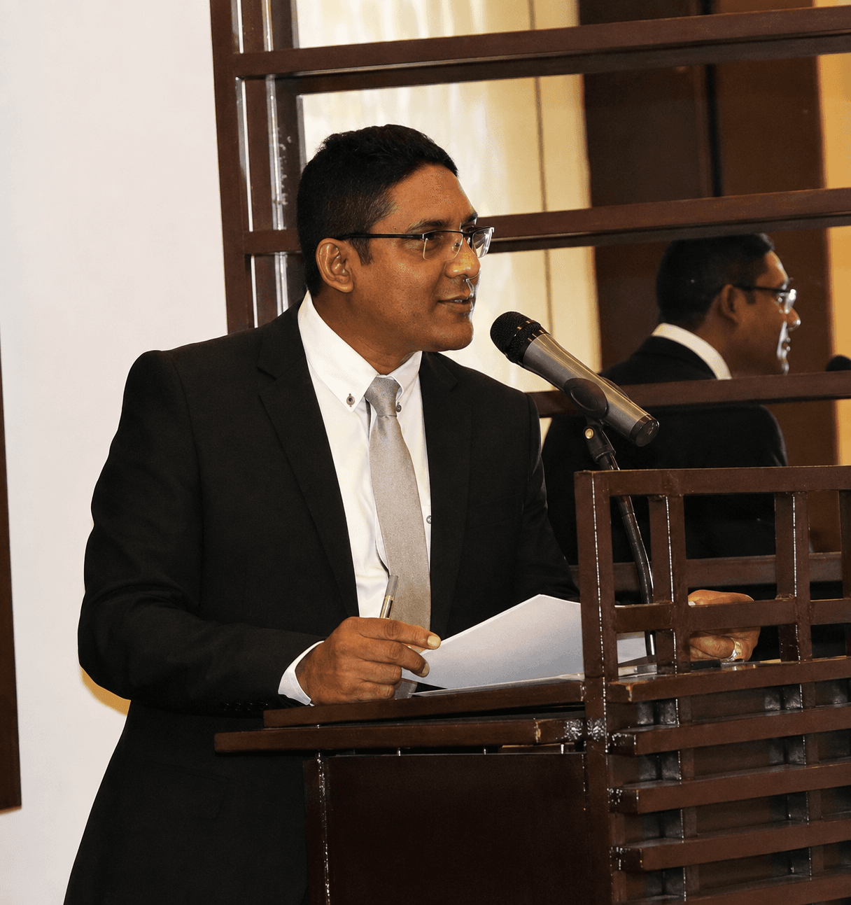 Mr. M. Anowar Hossain speaking at a podium